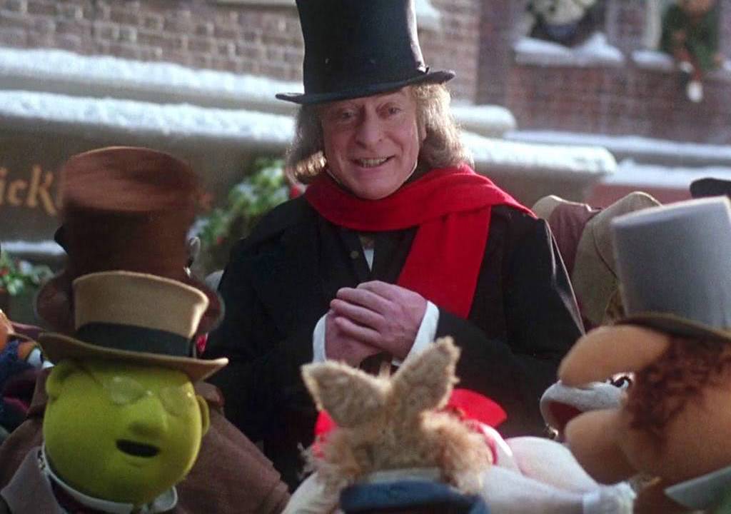 Scrooge surrounded by residents of Camden Town on Christmas morning.